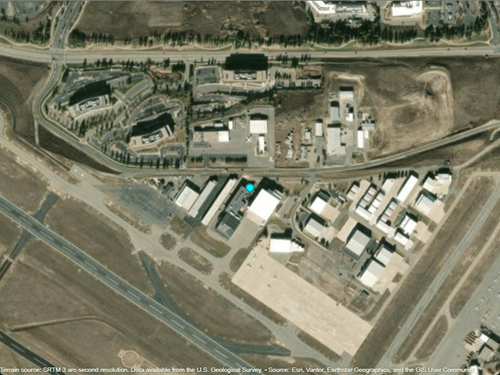 A cyan marker displayed over satellite imagery