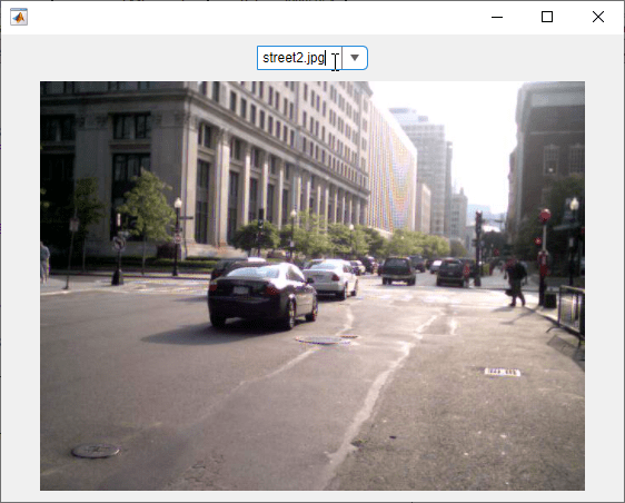 UI figure window with a drop-down list and an image of cars on a street. The drop-down list has the text "street2.jpg" and a cursor.